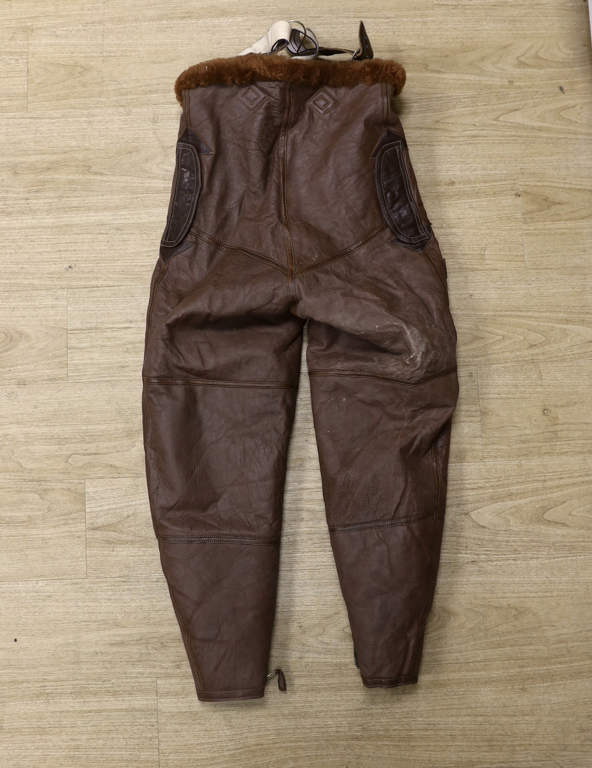 A pair of WWII Air Ministry issue RAF sheepskin breeches, with original label stating; ‘AM, Size: 5, Waist: 34-36, Seat: 40-42, Leg:32.5, 539778’, added in pen; ‘Brown’, provenance - by family descent